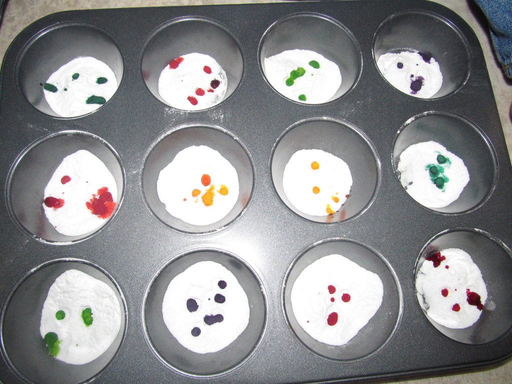 Step 2 - Add different colored drops of food dye in each spot on top of baking soda