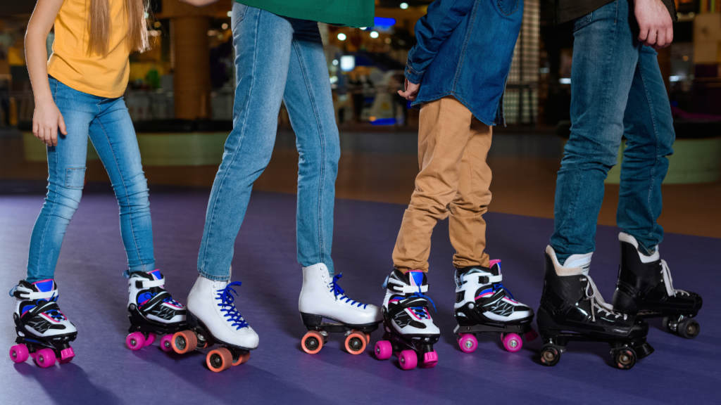 Legs of 4 people in roller skates.