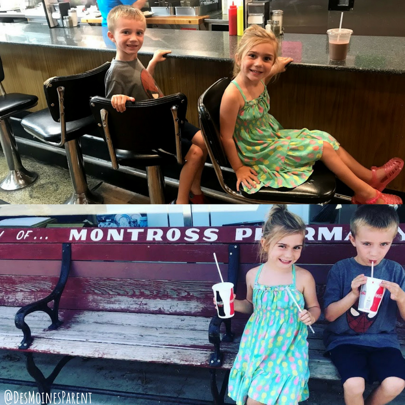 Boy and girl sitting at a counter with milkshakes.