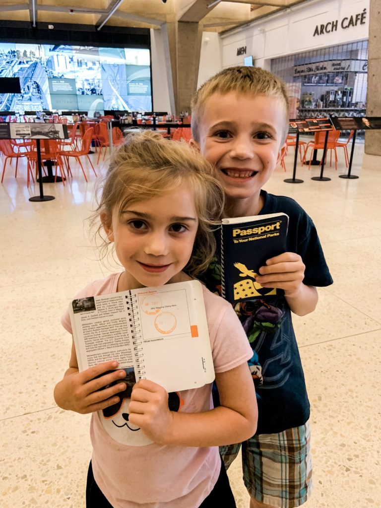 Brother and sister showing National Park Passport books.