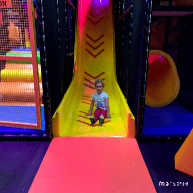 Girl coming down slide.