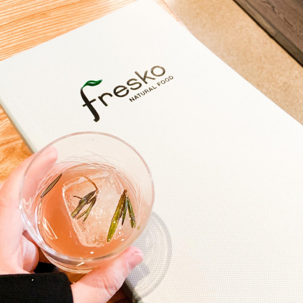 Overhead view of Fresko menu and cocktail.